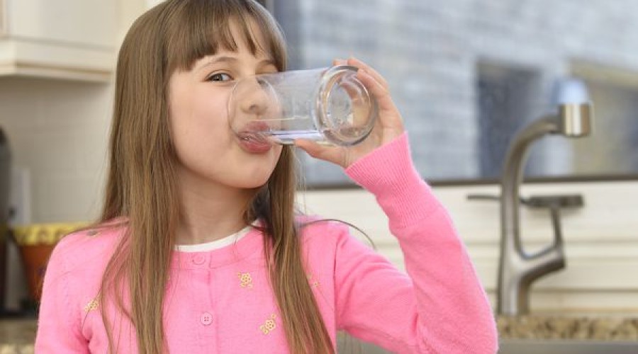Image of young girl drinking cold water