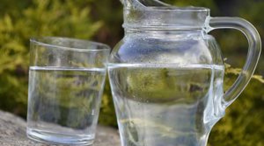 Jug of cold water beside a glass of water.