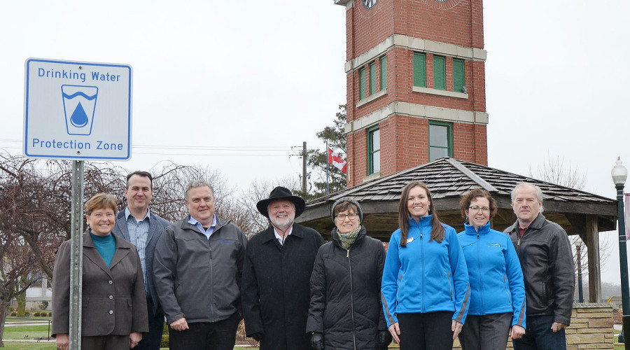 Source Protection Staff standing in front of a new sign